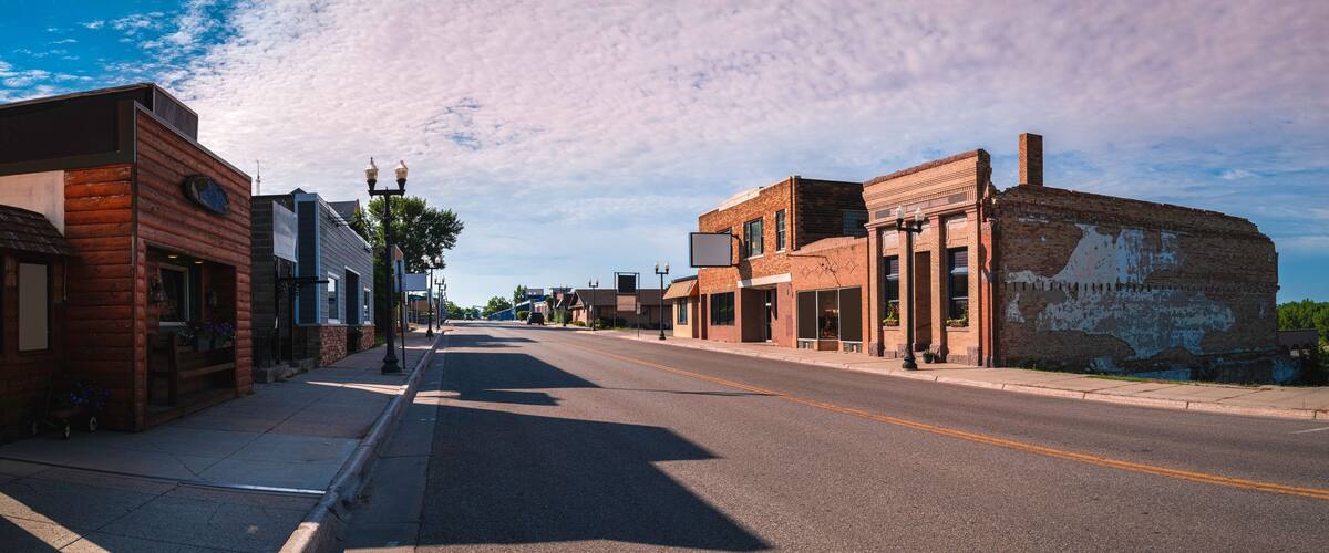 A quiet street lined with historic buildings and a clear blue sky.