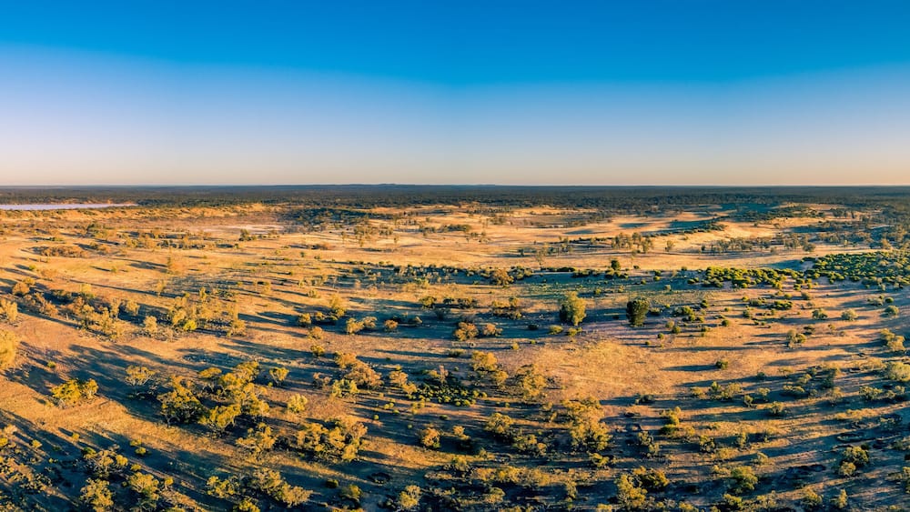 Wide aerial panorama of Australian outback at sunset