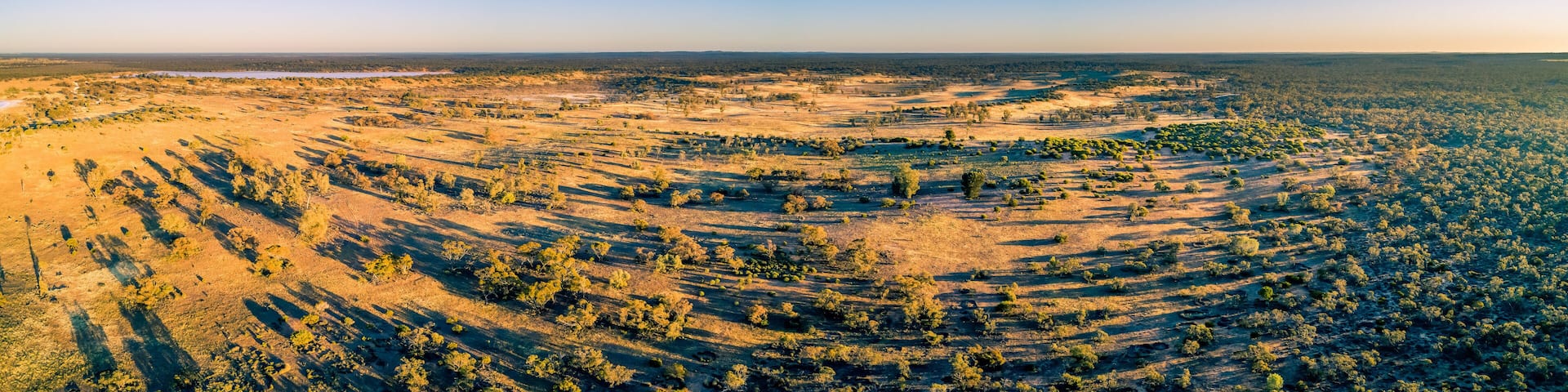Wide aerial panorama of Australian outback at sunset