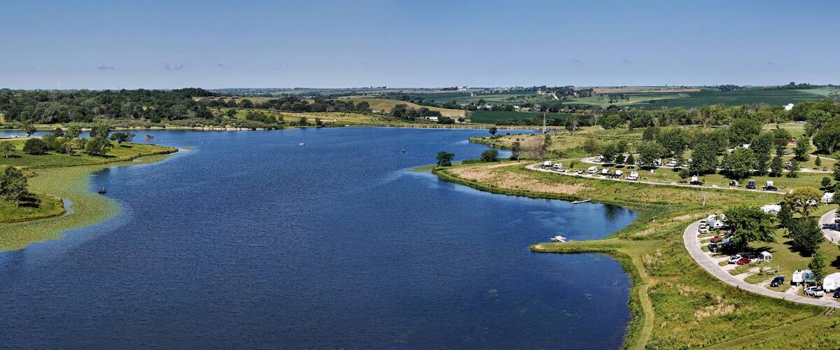 A large river winding through a green landscape with trees and fields.