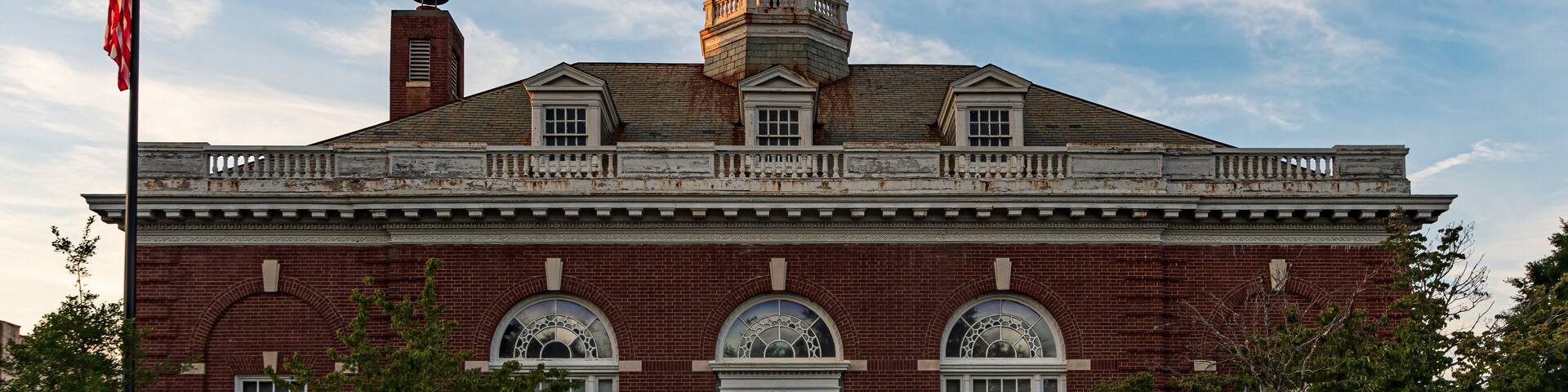 A historic brick building with a central dome and arched windows.