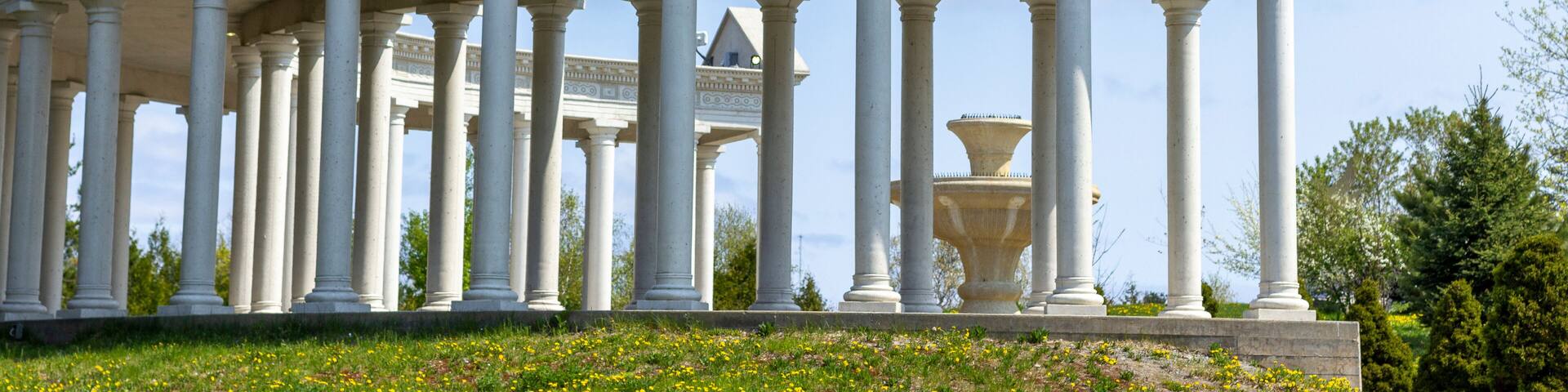A classical building with a series of columns and a triangular pediment.