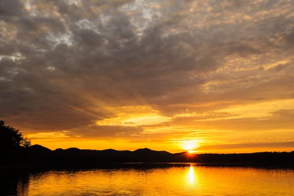 Golden sunlight reflecting on cave run lake at sunset; Morehead, kentucky, united states of america