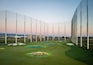 A golf course with bunkers and a clear sky.