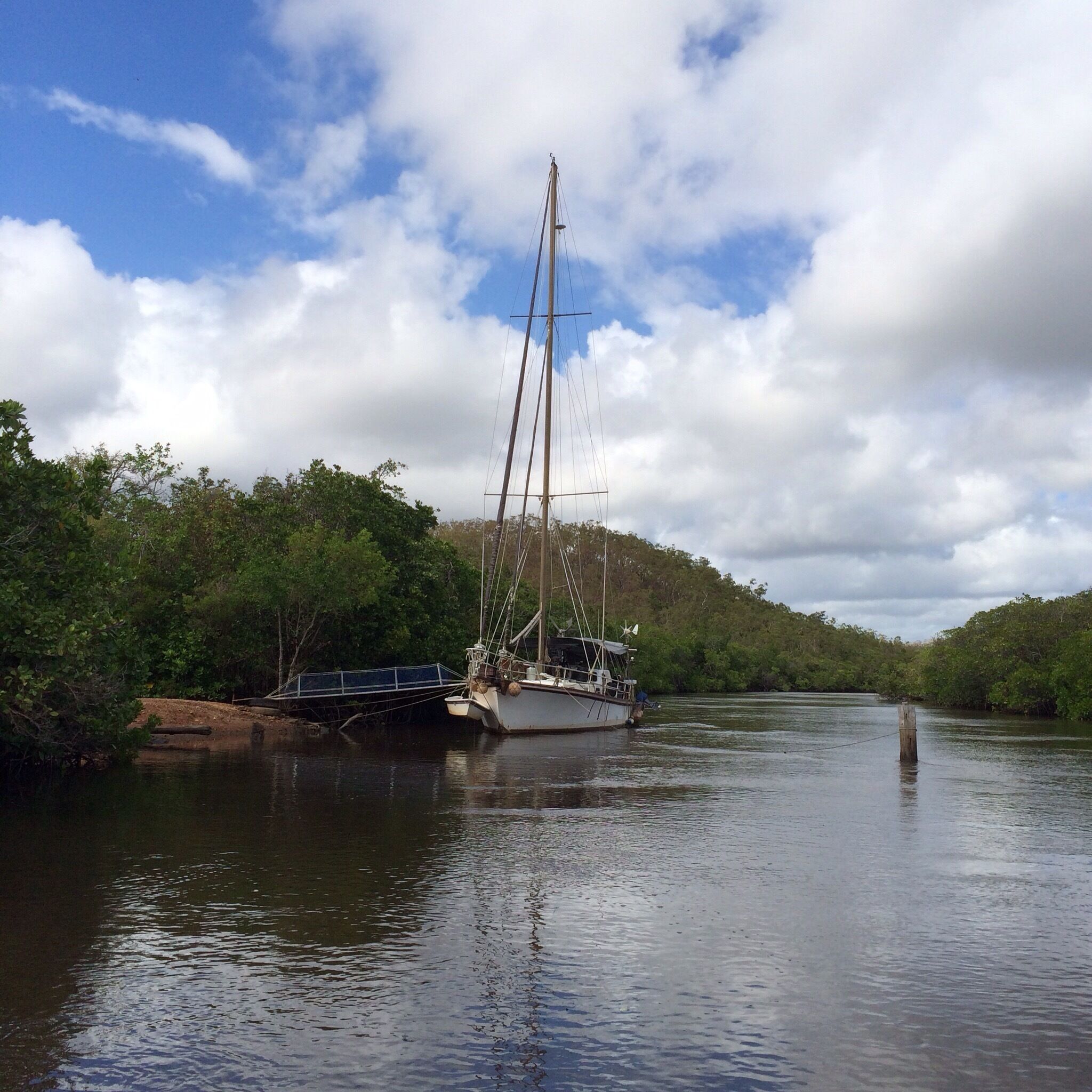 How some live!  
Endeavour River #NationalPark in Cooktown, #Australia - about a year ago, just 3 weeks after Cyclone Ita ravaged the area.
Most of this park is accessible only by boat and that's how I was able to take this photo with my iPhone5s.  
Took a little tin boat tour of the Endeavour River.  Saw a wide variety of spectacular mangroves, a few boat wrecks and this moored yacht. 
It was peaceful and undeveloped; the boat operator said that there were about 35 different species of mangrove.  
If one is in #FarNorthernQueensland, the tour is worth taking and just 3 of us in the boat.  
Unfiltered #iPhoneonly
#IloveaSunburntCountry
#roadtrip Cairns to Cooktown!