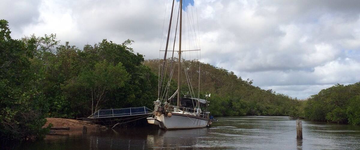How some live!  
Endeavour River #NationalPark in Cooktown, #Australia - about a year ago, just 3 weeks after Cyclone Ita ravaged the area.
Most of this park is accessible only by boat and that's how I was able to take this photo with my iPhone5s.  
Took a little tin boat tour of the Endeavour River.  Saw a wide variety of spectacular mangroves, a few boat wrecks and this moored yacht. 
It was peaceful and undeveloped; the boat operator said that there were about 35 different species of mangrove.  
If one is in #FarNorthernQueensland, the tour is worth taking and just 3 of us in the boat.  
Unfiltered #iPhoneonly
#IloveaSunburntCountry
#roadtrip Cairns to Cooktown!
