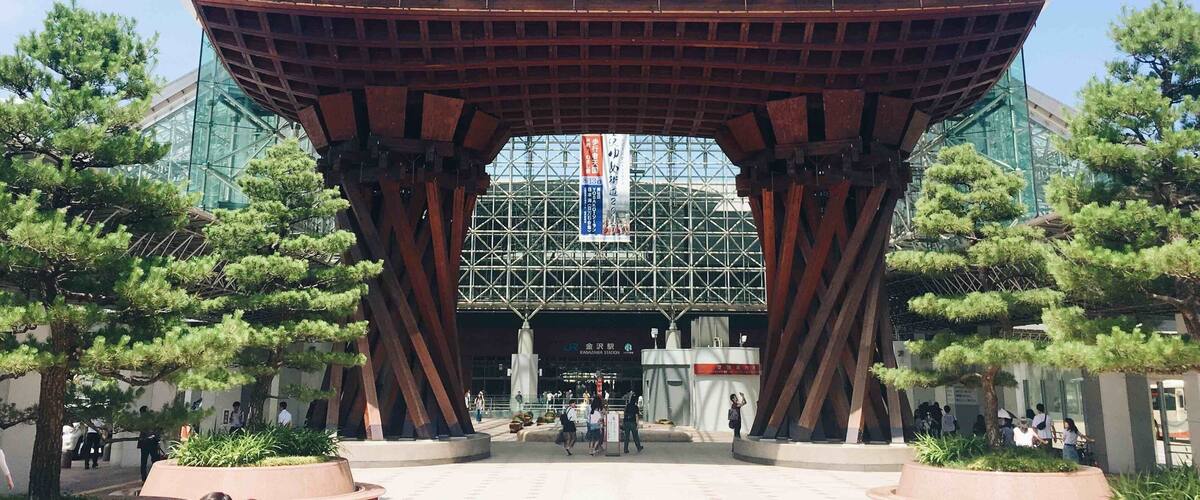 A modern architectural structure with a large overhang and metal framework.