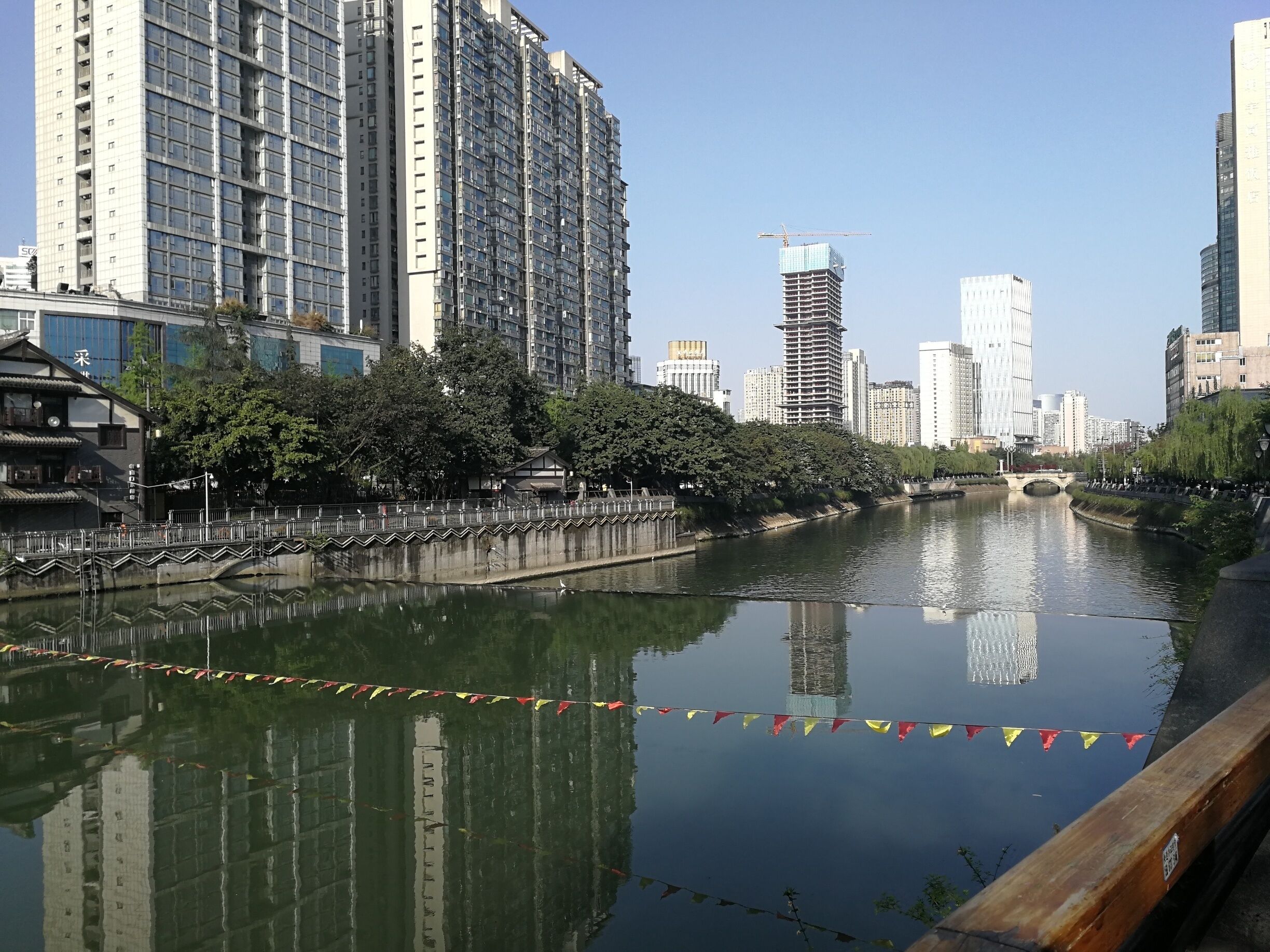 There are shady spots on sunny days along the river, and a range of good bars just up from the Jinjiang Hotel. 