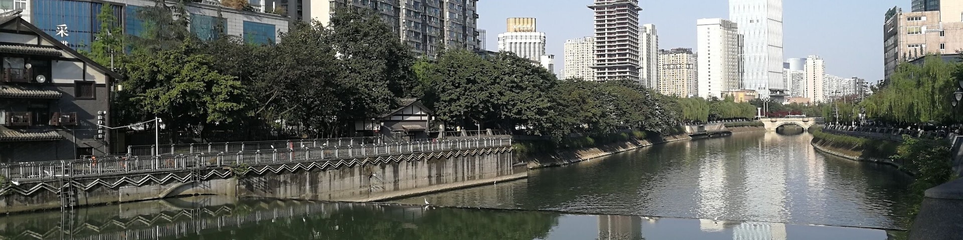 There are shady spots on sunny days along the river, and a range of good bars just up from the Jinjiang Hotel.