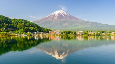 View of Lake Kawaguchiko with Mt Fuji in the background and its reflection. On a clear blue sky during spring season in Japan