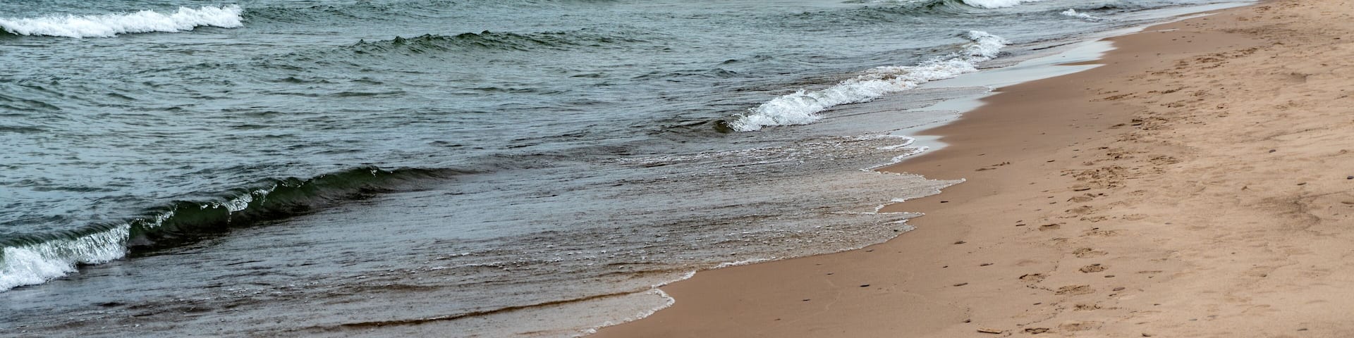 Indiana Dunes National Park along the southern shore of Lake Michigan. West Beach area, a popular beach portion of the park. Cleveland Cliffs, U.S. Steel’s Midwest Plant and Port of Indiana.