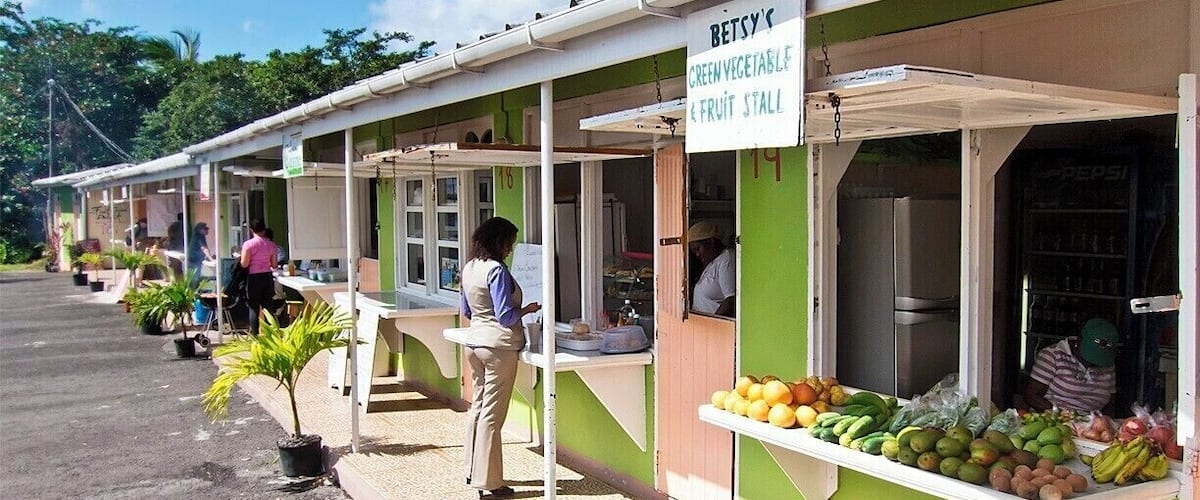 Convenient place to grab a meal while touring the island.  Local vendors rent space from a parallel strip of stalls where they sell food, drinks, snacks, produce, souvenirs and more.  Nelson's Grill House and A&E Fresh Fruit Juices did the trick for us.
Also a good place for a bathroom break, but bring some change as there's a small charge for keeping the potties clean.