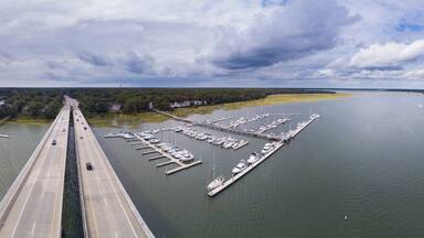 Aerial 360 degree view panorama of coastal highway bridge and marina in South Carolina.