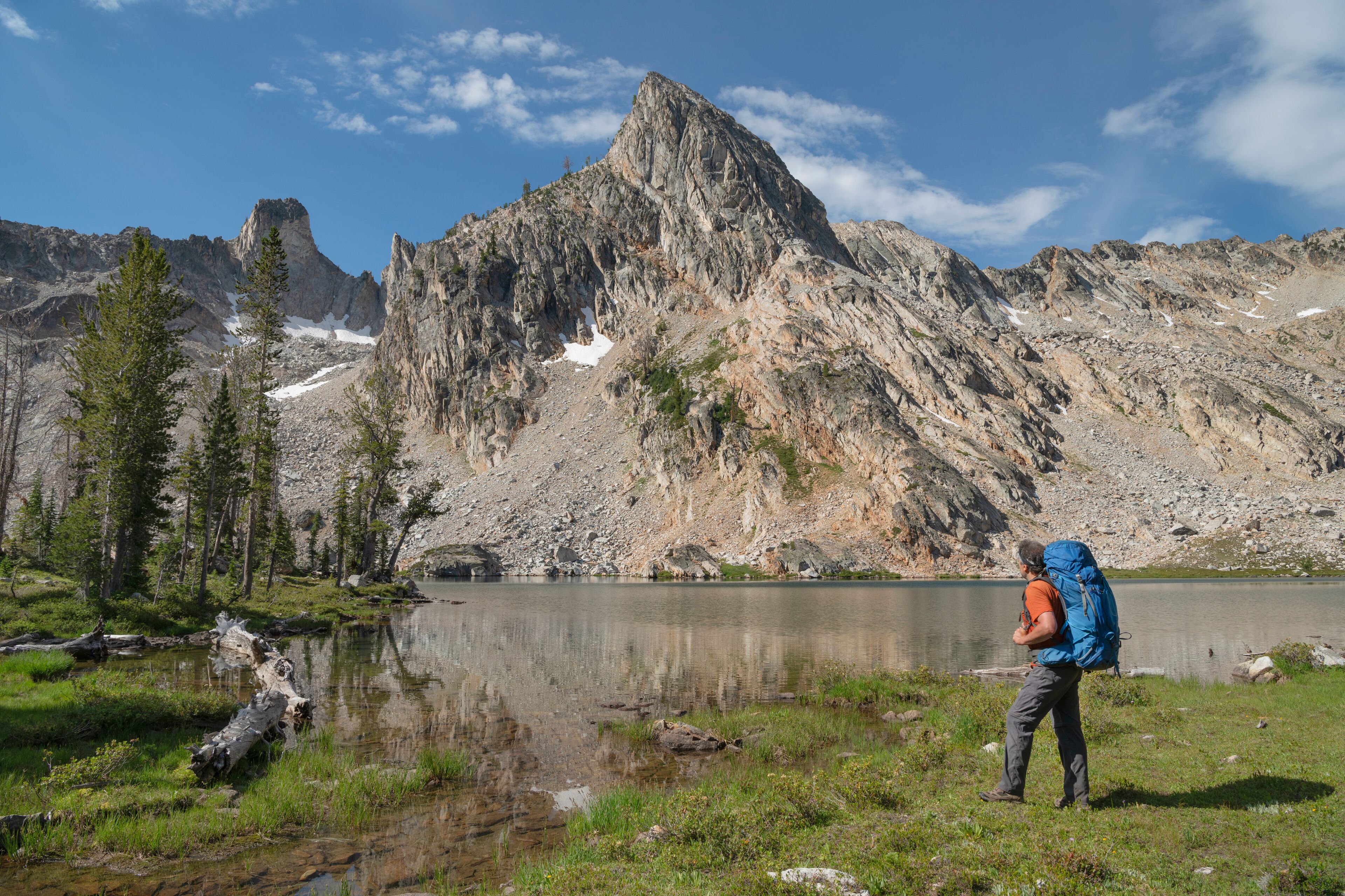 Adult male backpacker with blue pack at Twin Lakes on the Alice-Toxaway Lakes Loop Trail Sawtooth Mountains; Adult male Backpacker at Twin Lakes Alice-Toxaway Lakes Loop Trail Sawtooth Mountains Idaho. Idaho. United States