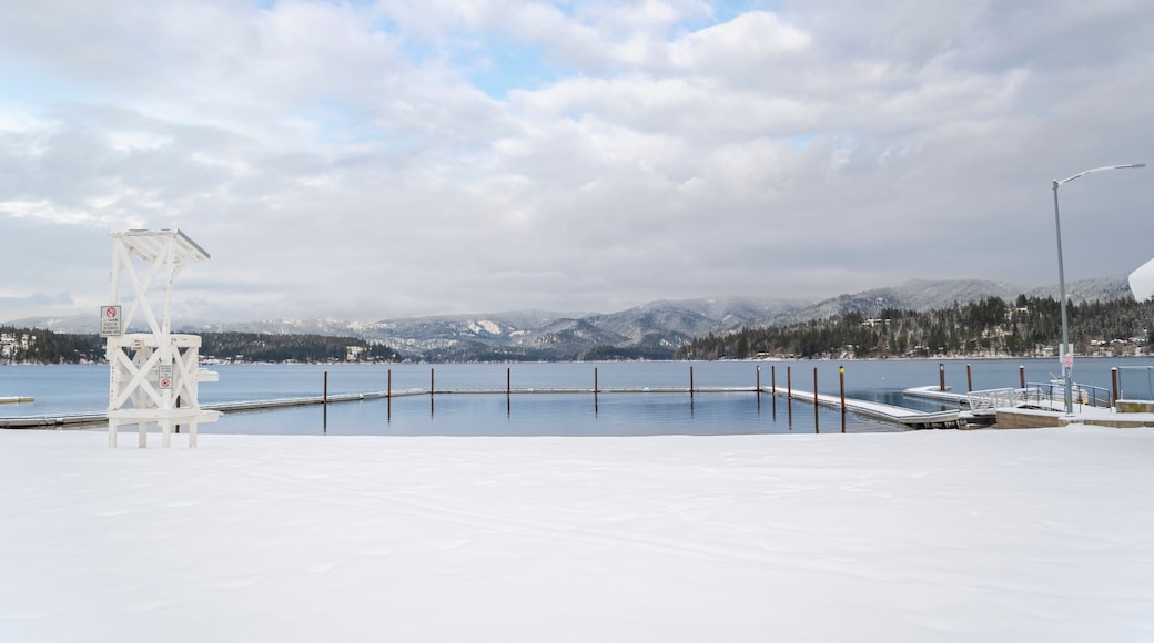 Snow covered winter view of the boat dock and swim area of Honeysuckle beach on Hayden Lake, in Hayden Lake, Idaho, USA
