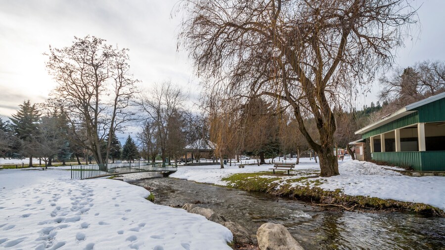 A small creek runs through the small public park with snow during winter at Rathdrum, Idaho USA.