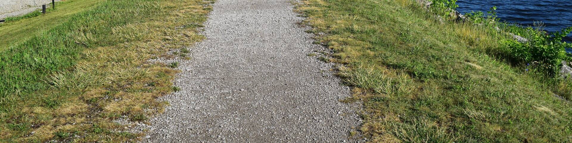 Barton dam, Ann Arbor. Summer landscape with a long riverside walkway beside Huron river