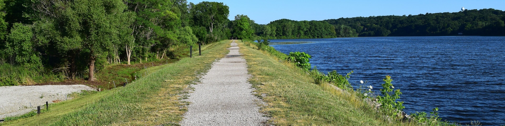 Barton dam, Ann Arbor. Summer landscape with a long riverside walkway beside Huron river