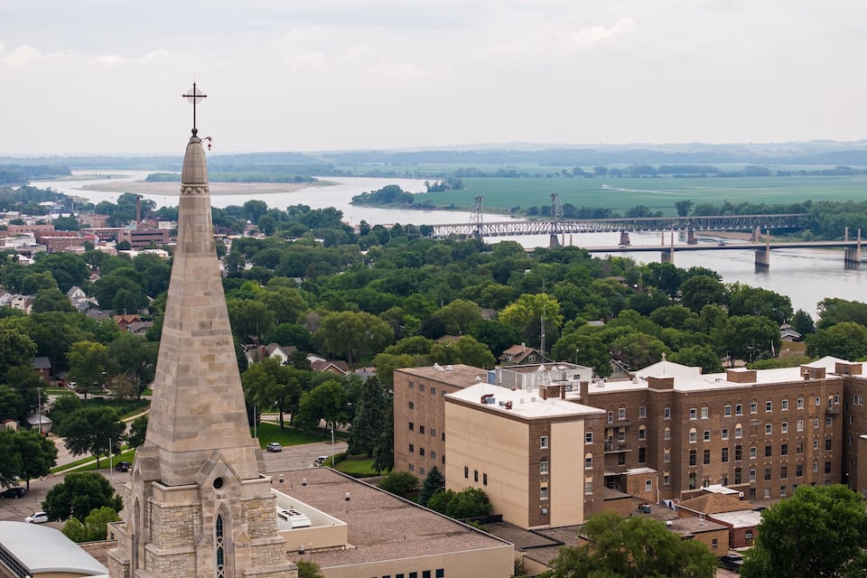 A church steeple, a river, and a bridge.