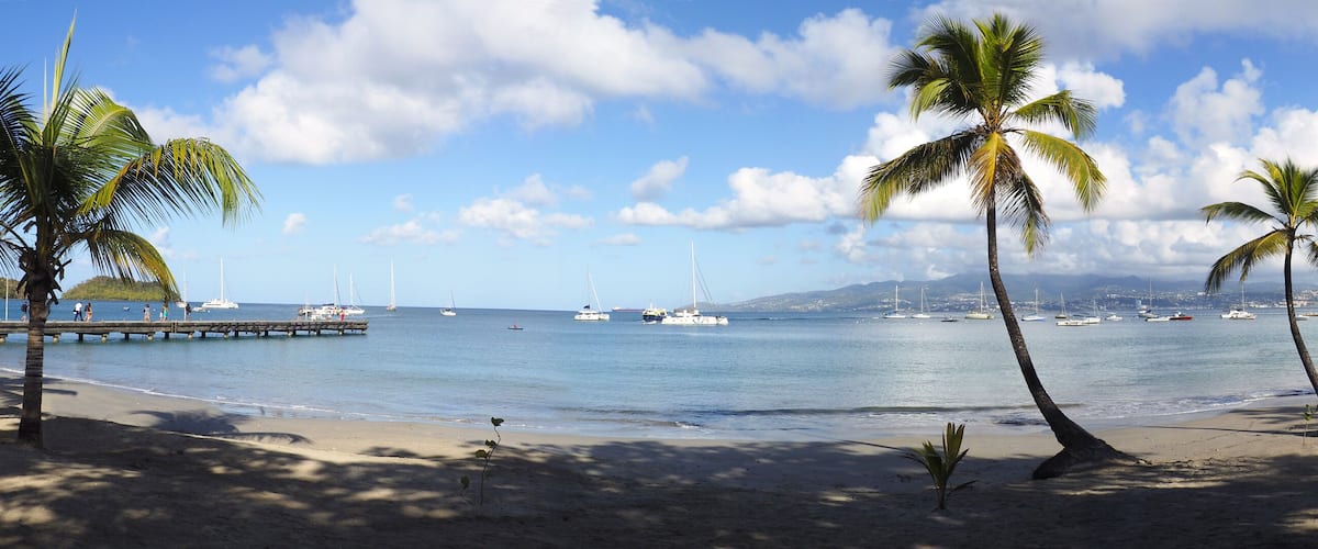 Superb panoramic view of the beautiful beach of Anse à l'Ane near the village of Trois-Ilets in Martinique facing the city of Fort-de-France