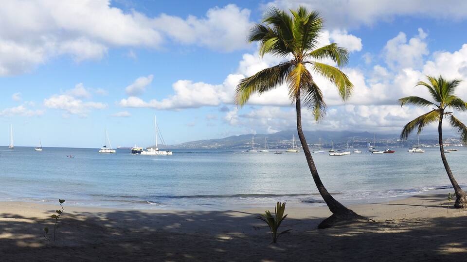 Superb panoramic view of the beautiful beach of Anse à l'Ane near the village of Trois-Ilets in Martinique facing the city of Fort-de-France