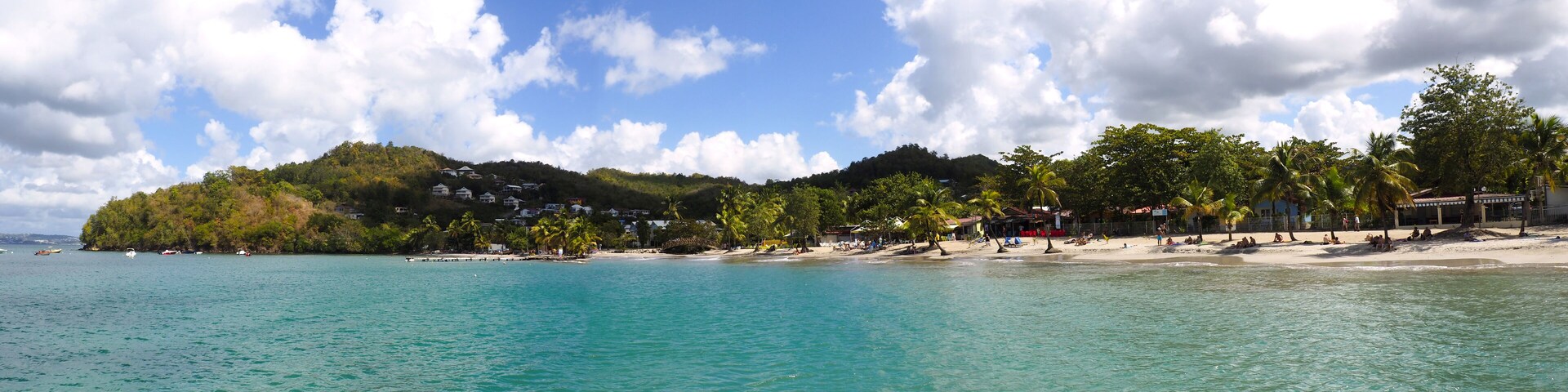 Superb panoramic view from the sea of the beautiful beach of Anse à l'Ane near the village of Trois-Ilets in Martinique facing the city of Fort-de-France