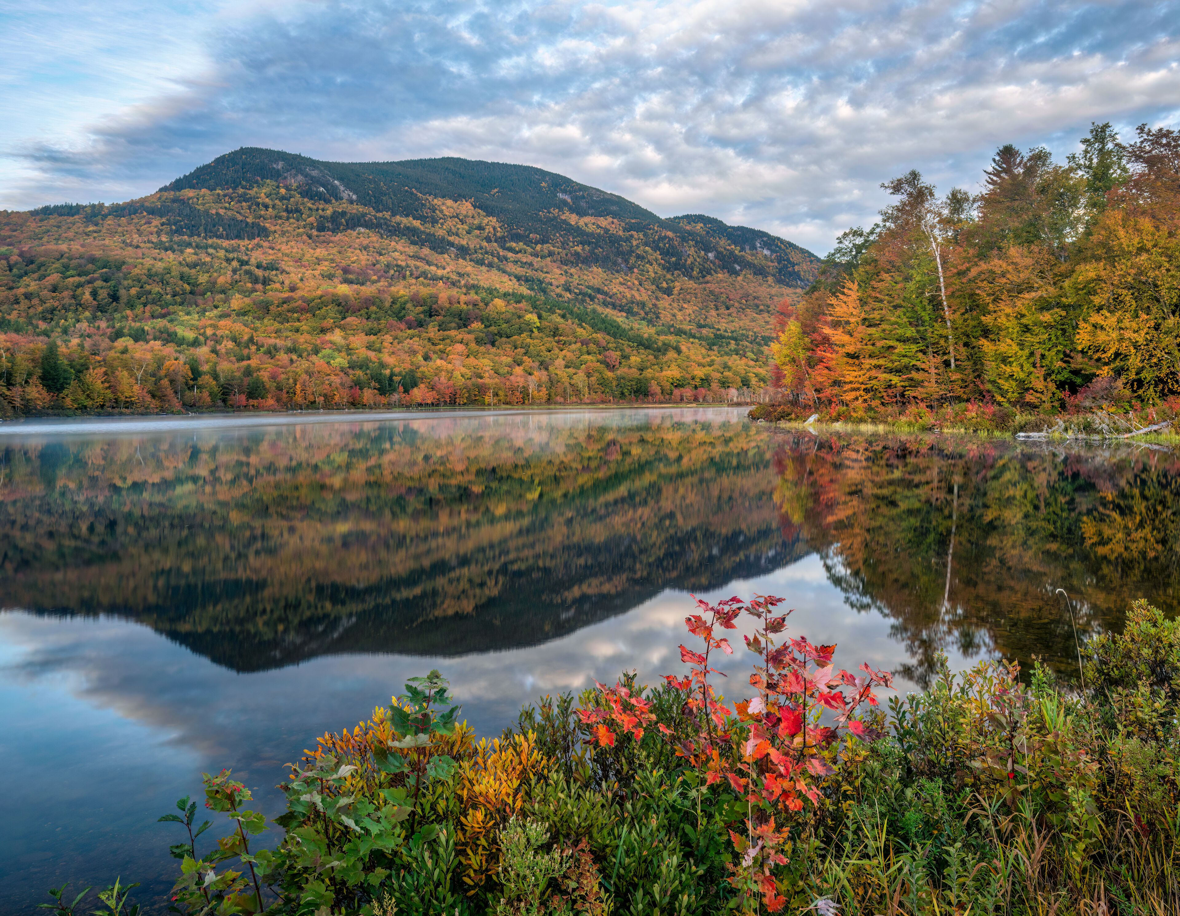 Autumn panorama with reflection at the Basin Brook Reservoir in the White Mountains of New Hampshire