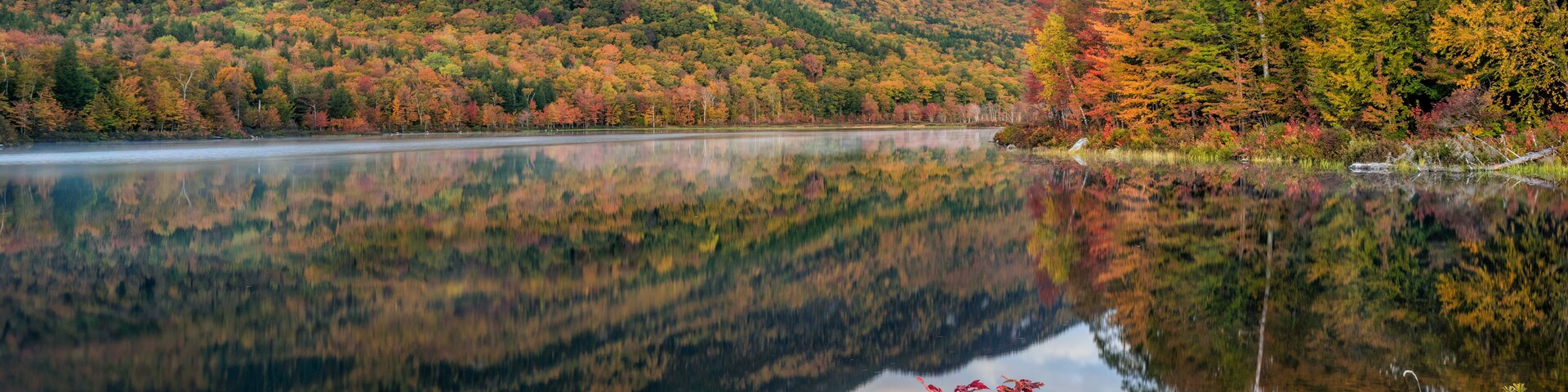 Autumn panorama with reflection at the Basin Brook Reservoir in the White Mountains of New Hampshire