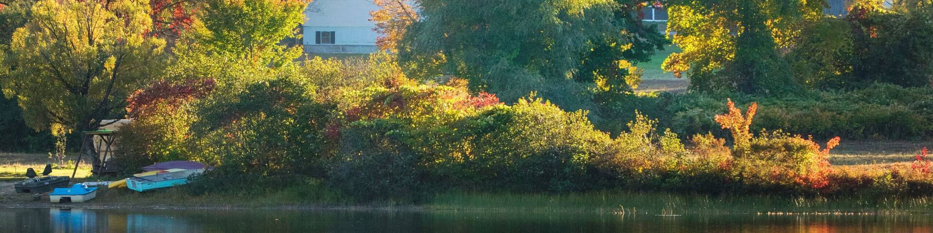 little church reflected in a pond in new england