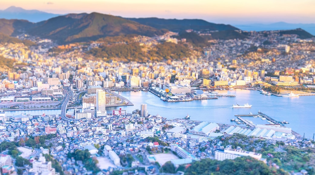 Business concept, tilt shift effect modern cityscape of nagasaki dusk from mount inasa, the new top 3 nightview of the world, aerial view, copy space