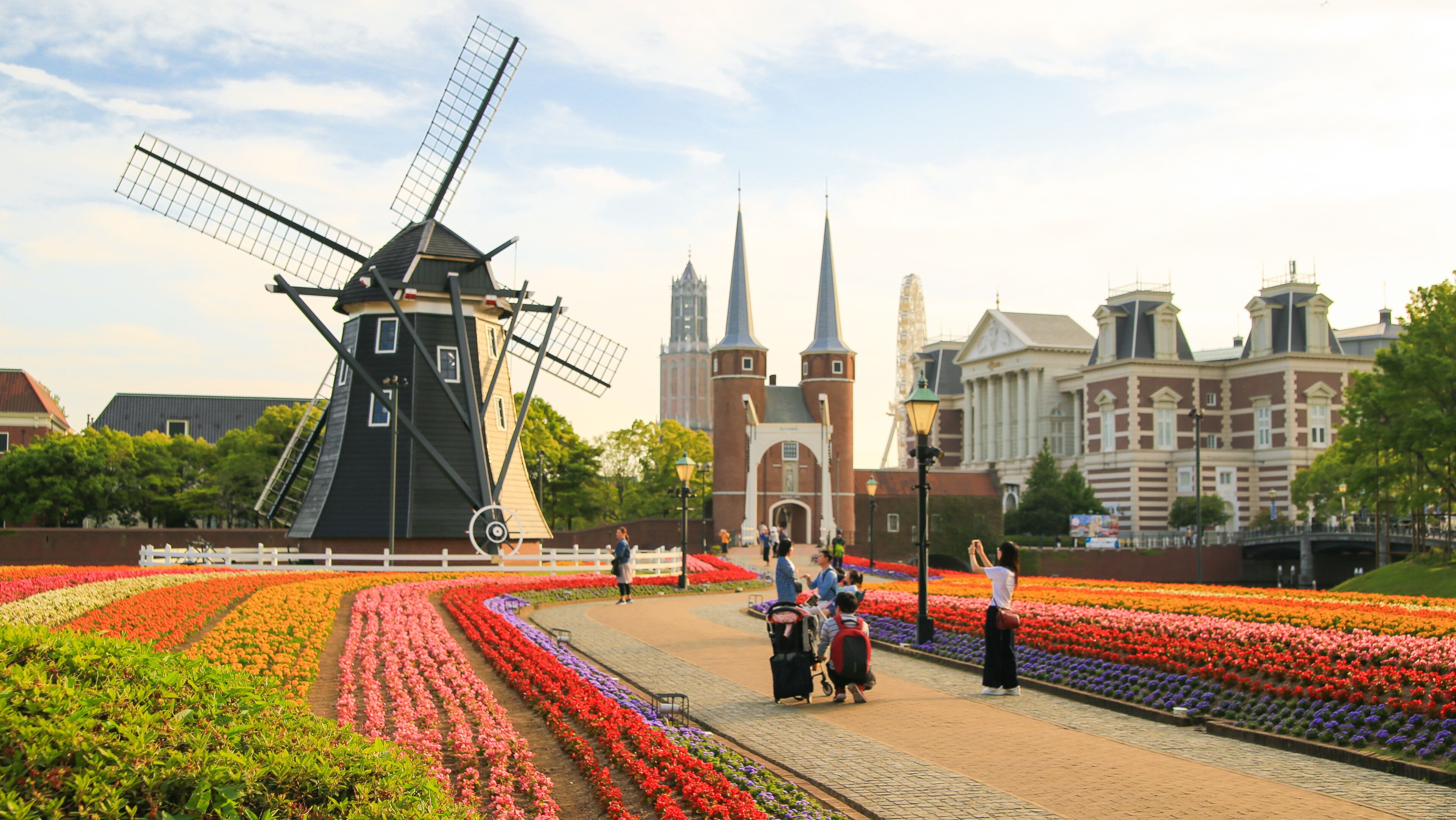 A windmill, flower gardens, and historic buildings.