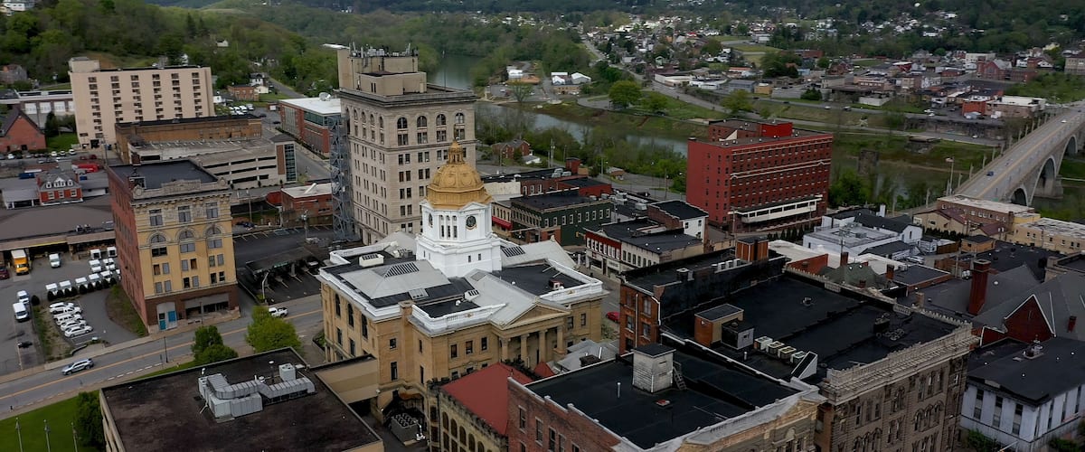 Low altitude aerial view with stormy sky centered on the Marion County courthouse in Fairmont, West Virginia.