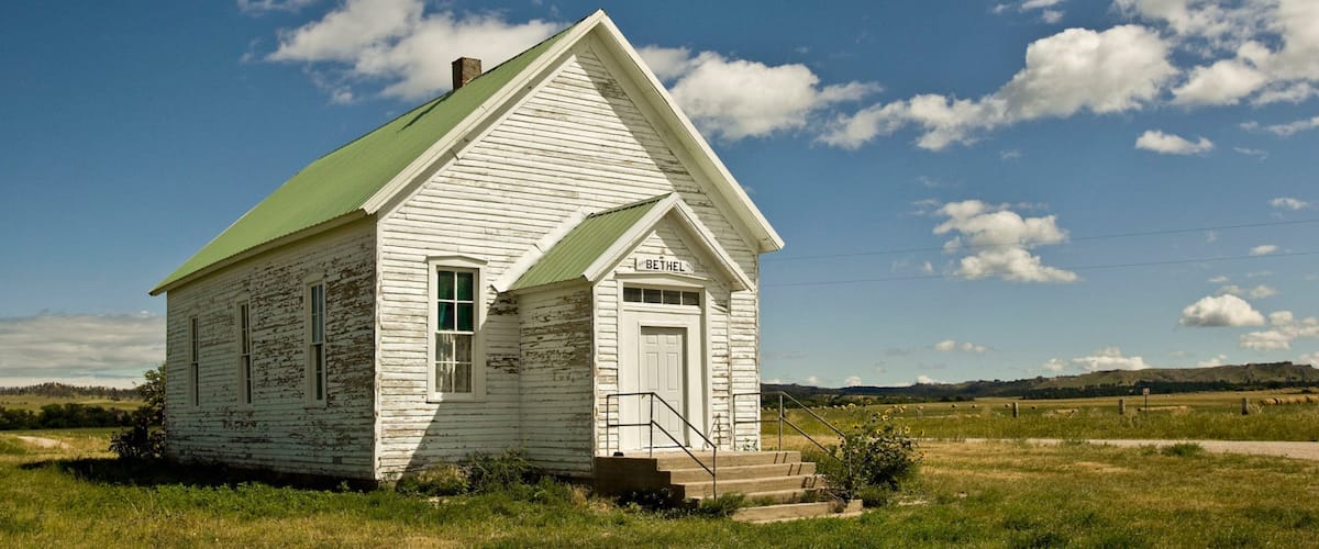 A white church with a green roof named Bethel in a rural setting.