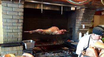 That's a lamb roasting in the middle of the restaurant. Deals are being done over spanikopita and tsatsiki. Great spot