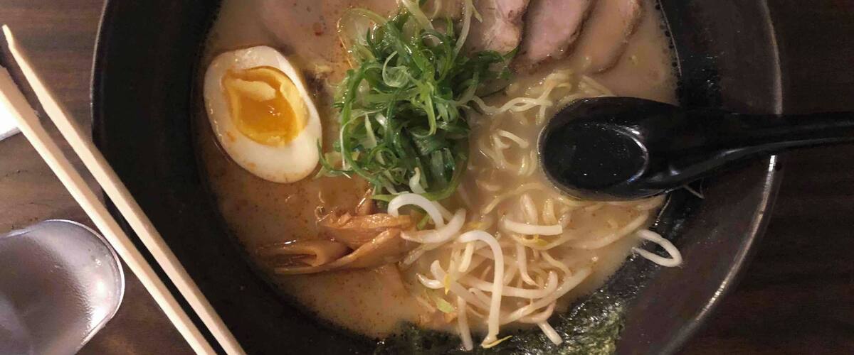 On a busy street between a gas station and a small school is not where you’d expect to find a ramen restaurant. 
Put your name on a list when you enter and wait outside until called (it’s California so weather shouldn’t be a problem). Service is quick and food is hot and delicious!
