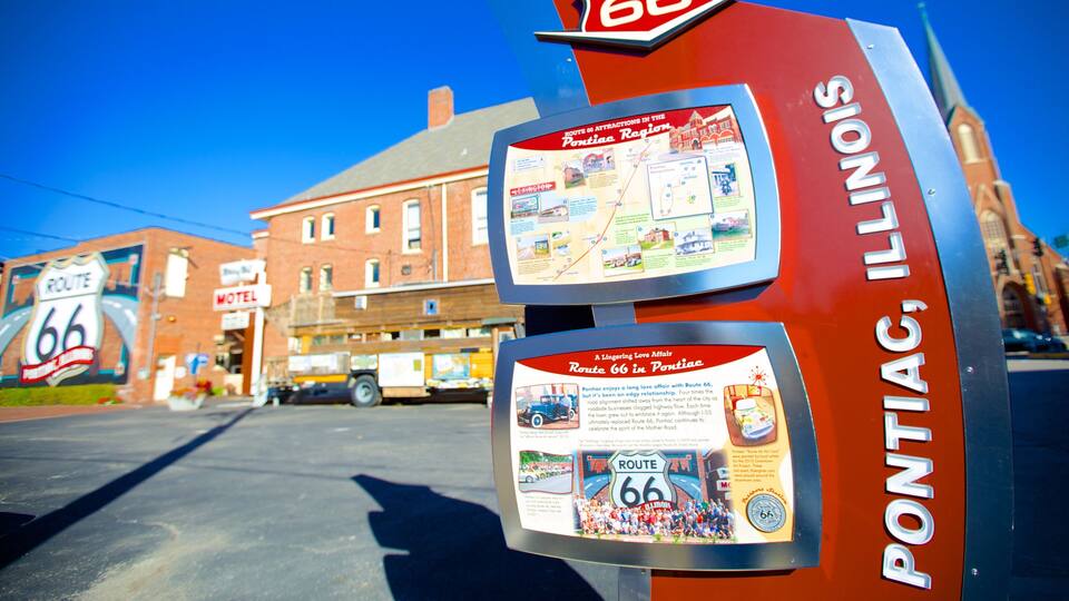 A Route 66 sign in Pontiac, Illinois, with a vintage car and a map of Route 66.