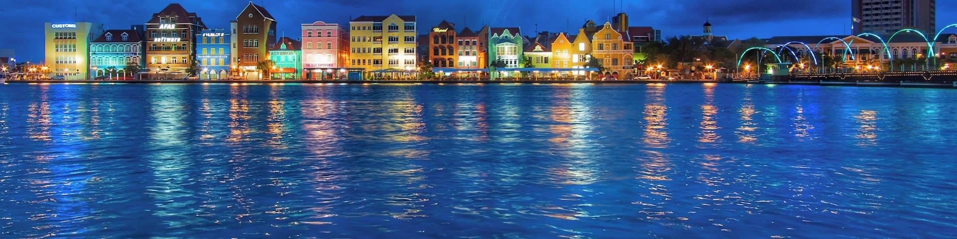 The harbor view in the port area of Willemstad at night
