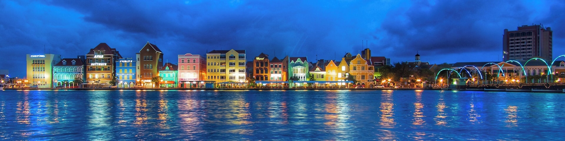 The harbor view in the port area of Willemstad at night