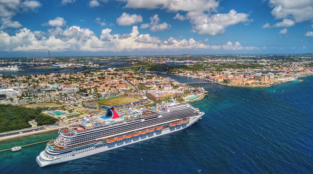 Drone shot hovering off the coast of Willemstad with the Carnival Horizon in Port