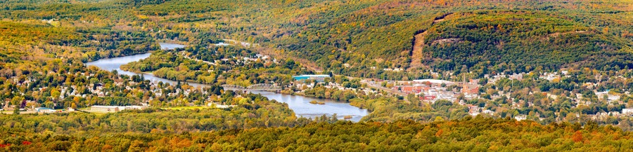 Aerial view of the City of Port Jervis, NY crossed by Upper Delaware river as viewed from High Point peak, NJ