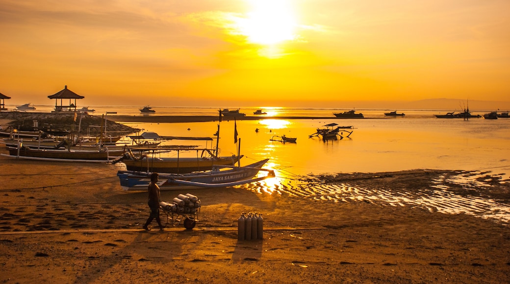 Traditional Balinese boats and pavilion in Sanur beach in the morning at dawn, Bali, Indonesia.