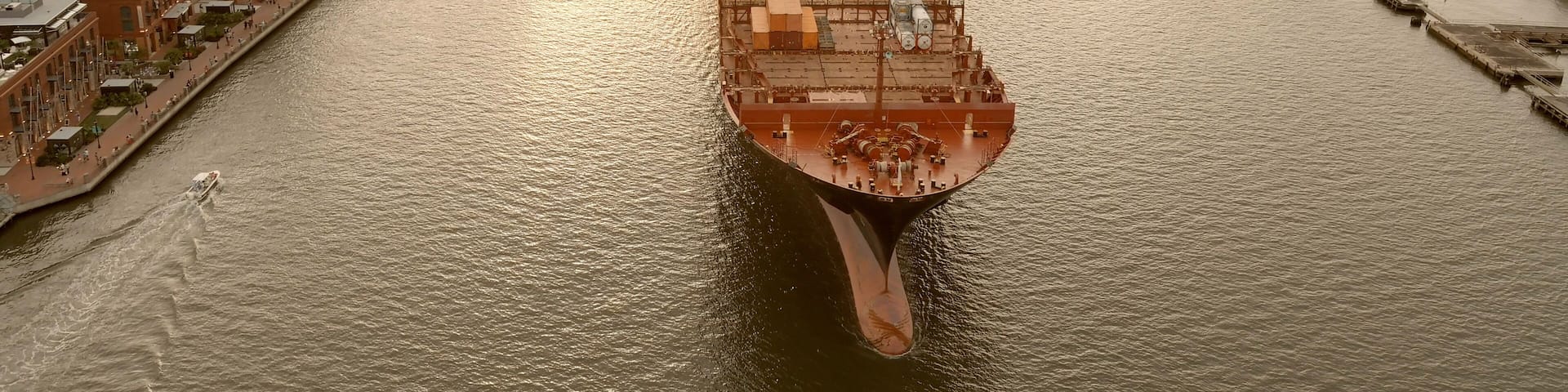 A large container ship leaves the port of Savannah after offloading its cargo.