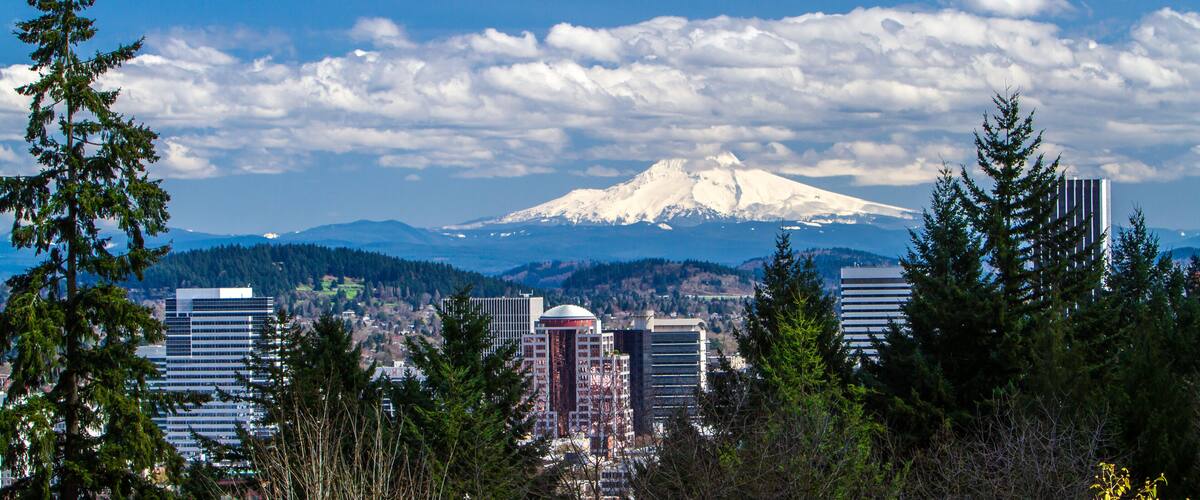 Portland, Oregon; View of snow covered Mt Hood and buildings in downtown Portland, Oregon