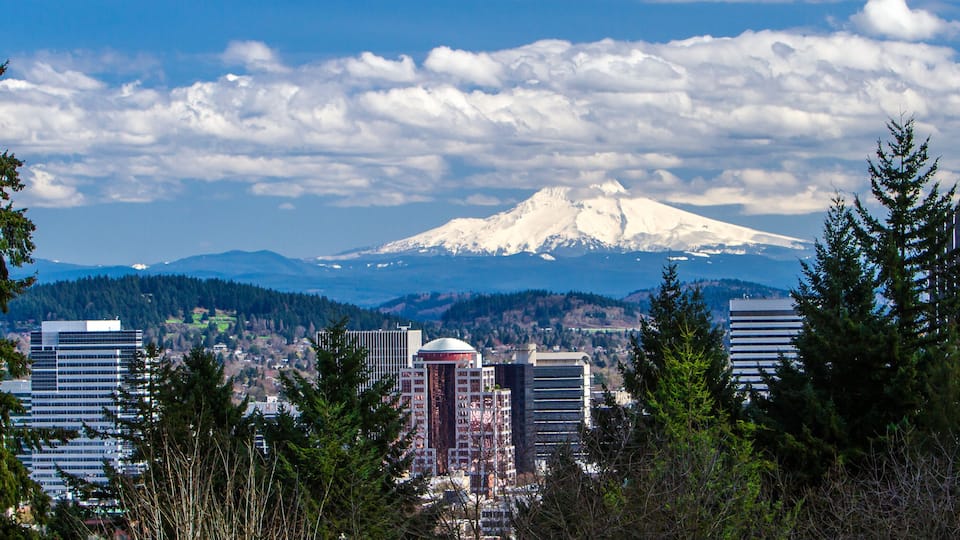 Portland, Oregon; View of snow covered Mt Hood and buildings in downtown Portland, Oregon