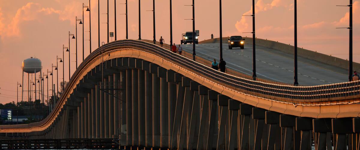 Barron Collier Bridge and Gilchrist Bridge in Florida with moving traffic. Transportation infrastructure in Charlotte County connecting Punta Gorda and Port Charlotte over Peace River