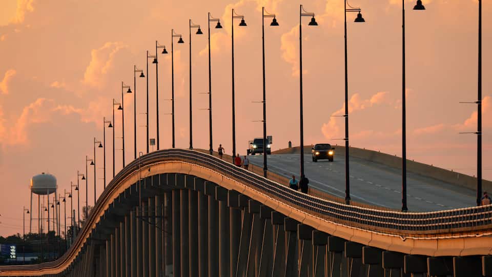 Barron Collier Bridge and Gilchrist Bridge in Florida with moving traffic. Transportation infrastructure in Charlotte County connecting Punta Gorda and Port Charlotte over Peace River
