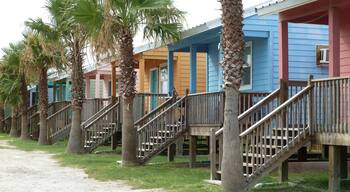 Row of small colorful wooden tiny beach houses and palm trees, Gulf of Mexico
