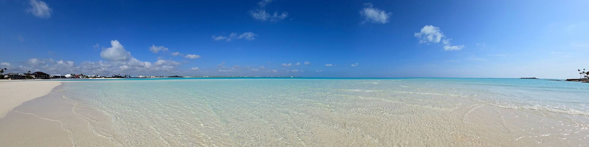Panorama of sandbar and clear shallow water of Treasure Cay, Abaco, Bahamas on sunny summer day.