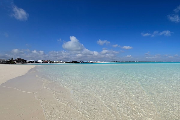 Panorama of sandbar and clear shallow water of Treasure Cay, Abaco, Bahamas on sunny summer day.