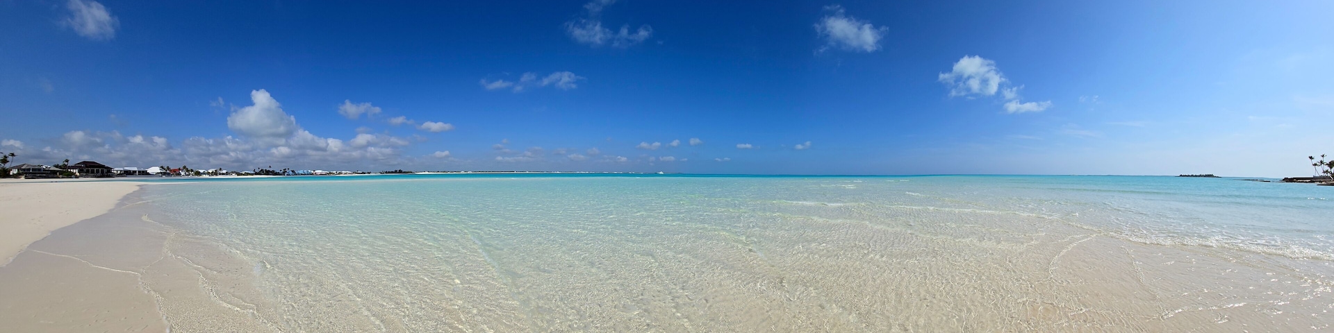 Panorama of sandbar and clear shallow water of Treasure Cay, Abaco, Bahamas on sunny summer day.